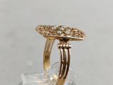 a close up of a gold ring with pearls on it