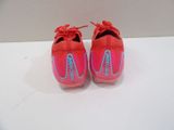 pair of pink and blue nike shoes on a white surface