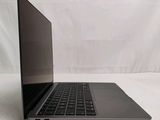 a laptop that is sitting on a white surface