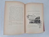 an open book with a picture of a mountain in it