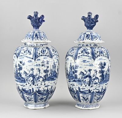 pair of blue and white vases with figures on them