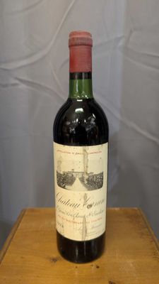 a bottle of wine sitting on a wooden table