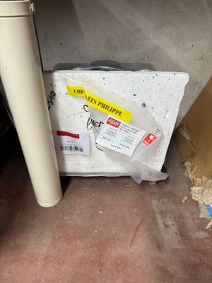 a box of toilet paper sitting on the floor next to a toilet