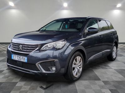 a blue suv parked in a garage with a checkered floor