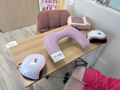 a table with a pink and white hair dryer and a pink and white hair dryer on it