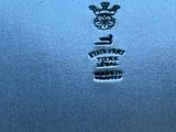an image of a close up of a metal plate with a logo on it