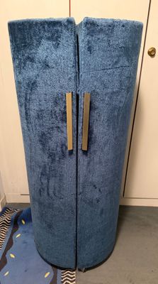 a tall blue cabinet with two doors in a room