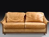 an image of a brown leather couch sitting on top of a gray floor