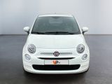 the small white car is parked in a large room