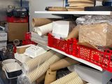 many cups and containers on the shelves in the kitchen