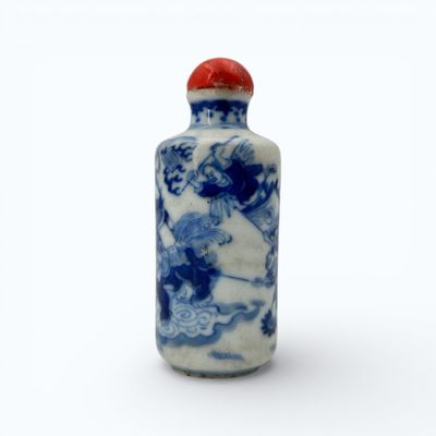 a small blue and white bottle with a red lid