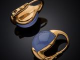 a pair of gold and blue glass earrings