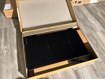 a box that has a laptop inside of it on the floor