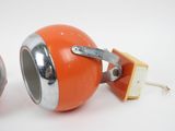 two orange and silver speakers sitting next to each other