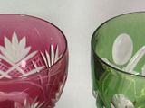 two wine glasses sitting next to each other on a table