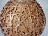 a close up of a vase on a white surface