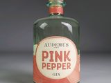 a bottle of pink pepper gin sitting on a table