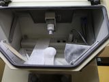 a toilet that has a seat and a toilet paper dispenser in it