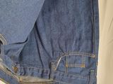 the back of a pair of blue jeans with a white tag on it