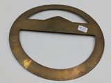a close up of a metal circle with a mountain in the middle