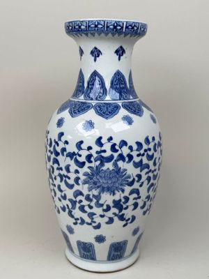 a blue and white vase sitting on a table