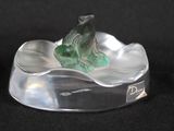 statue of a frog sitting on a leaf in a glass bowl