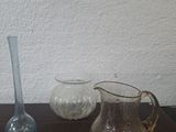 three glass vases sitting on a table next to each other
