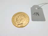 a gold coin with a price tag attached to it