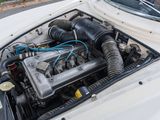 a small engine in the hood of a white car
