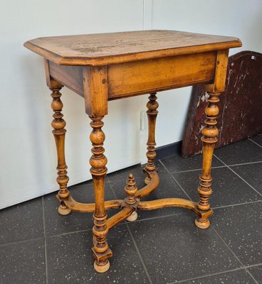 a small table with a wooden top on a tiled floor