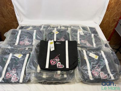 many bags of luggage sitting on a bed in a room