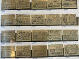 a lot of old paper money on display in a glass case