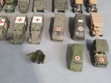 a lot of toy army vehicles that are on the table