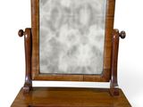 a small mirror sitting on top of a wooden stand