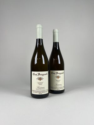two bottles of wine sitting next to each other on a table