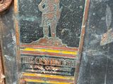a rusted metal box with a picture of a soldier on it