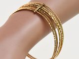gold plated bang bracelets on a mannequin hand