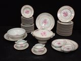 a lot of plates and bowls that are sitting on a table