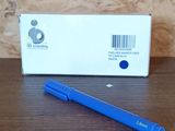 a blue pen sitting on a table next to a box