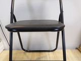 a black chair that is sitting on a wooden floor
