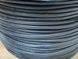 an image of a stack of black wires on a wooden table