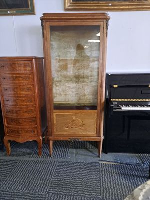 a piano and a cabinet in the corner of a room