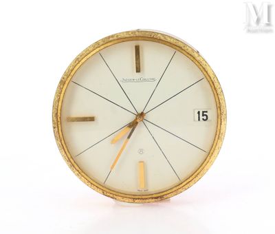 a clock that is sitting on a white surface