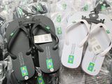 two pairs of flip flops that are on the ground