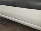 a close up of a white car with a black stripe on it