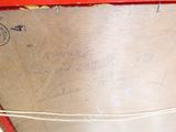 a red suitcase with writing on it sitting on a table