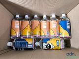 several bottles of water in a cardboard box on a table