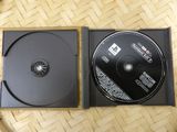 a black cd case with a black disc inside of it