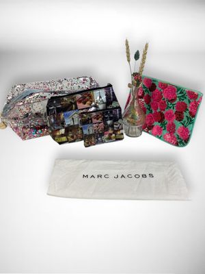 marc jacobs handbags and purses are displayed on a white surface