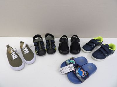 Plusieurs paires de chaussures d'enfants sont alignées sur une table